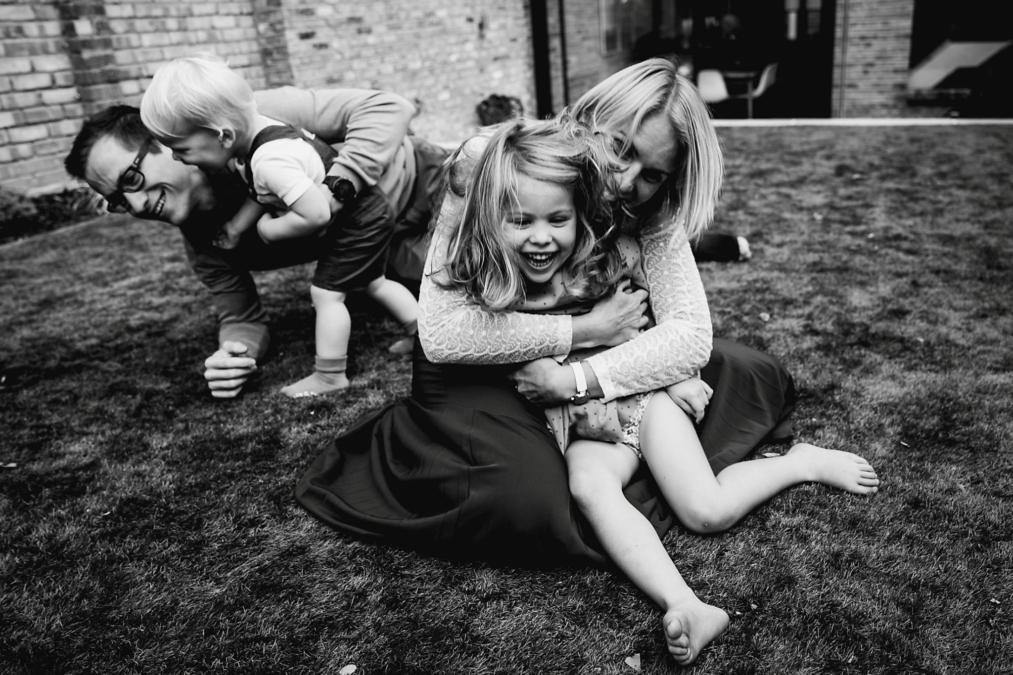 Family Life Session - Family playing tag in the back garden