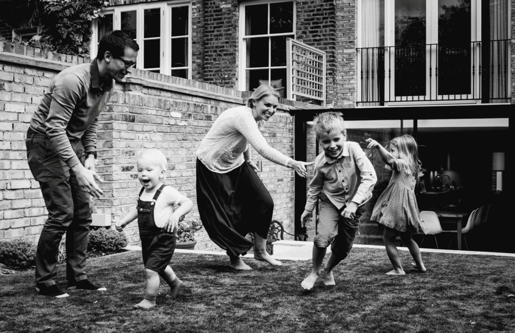 Family enjoying playing in the garden - Award winning documentary family photography