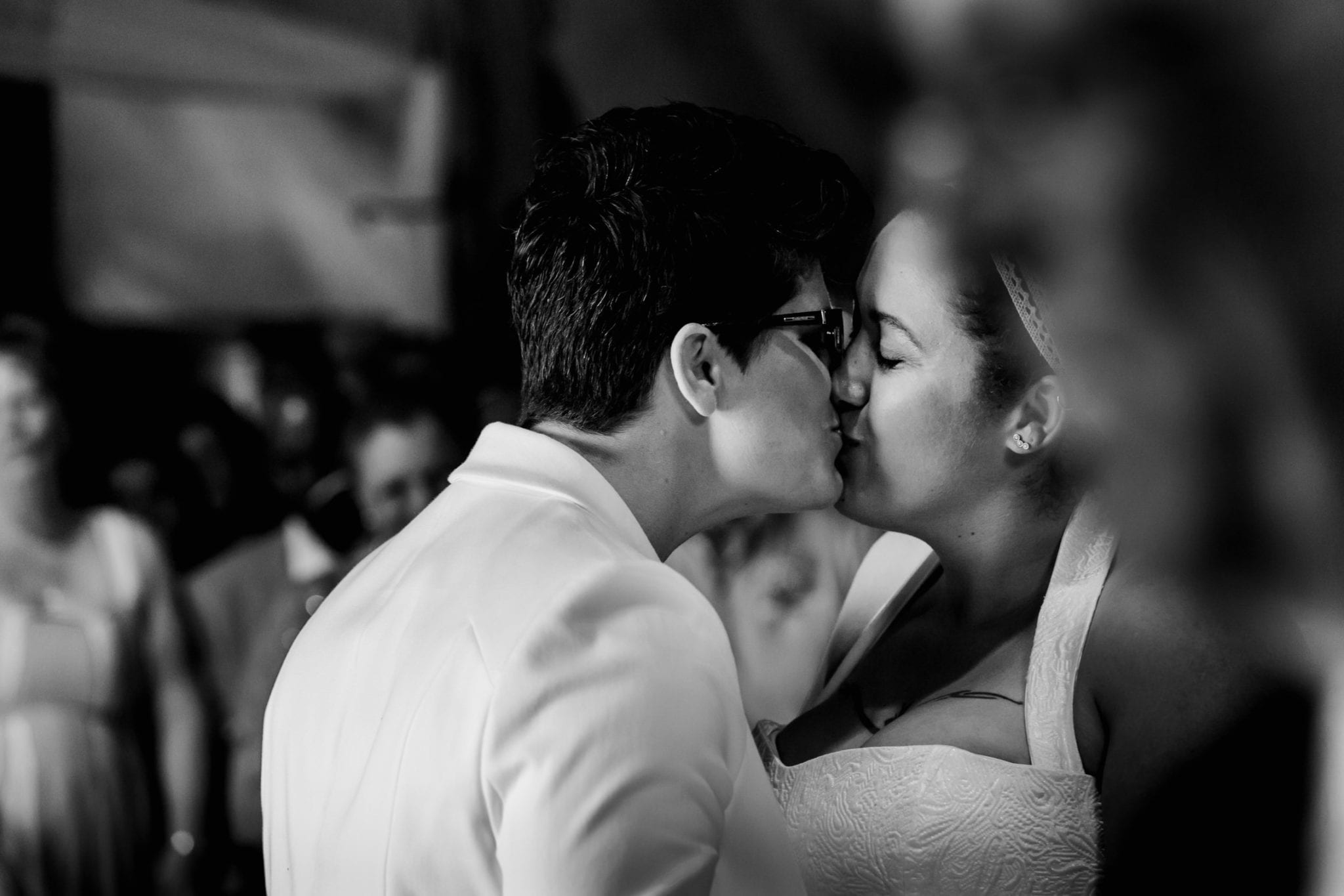 Two brides kissing on their wedding day