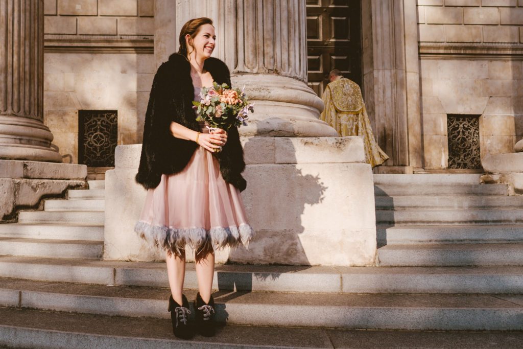 Bride poses outside St Paul's Cathedral London