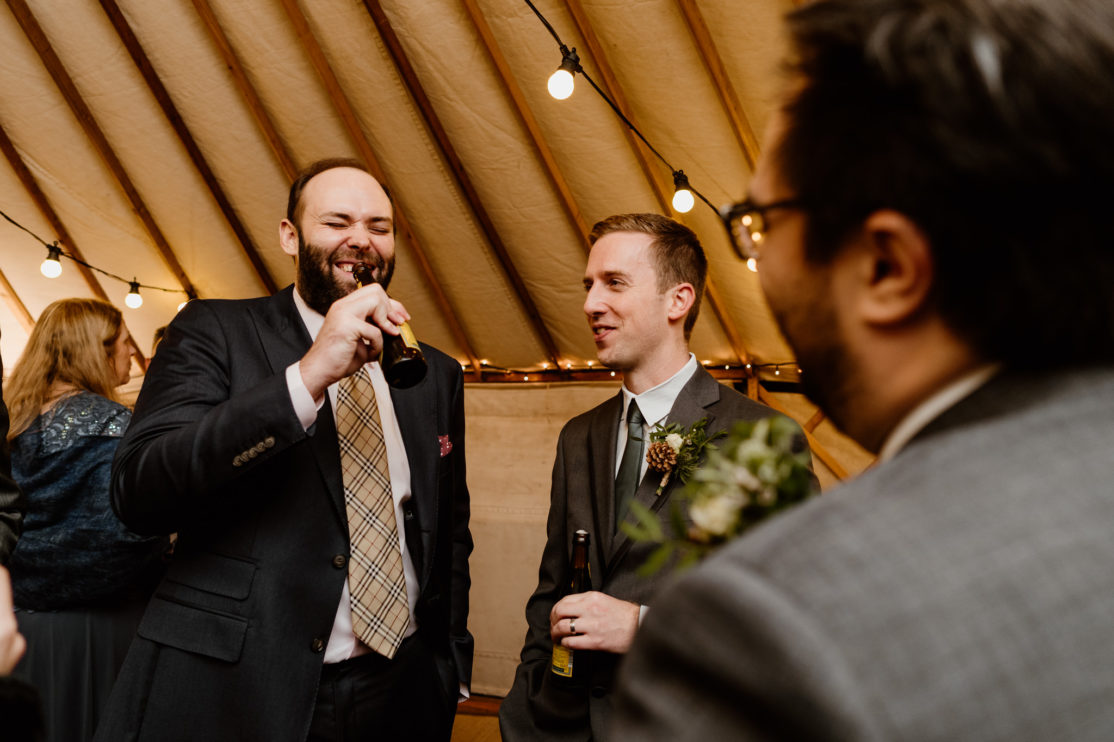 Weddings guests laughing at Old Luxters Barn, Buckinghamshire Wedding Photography
