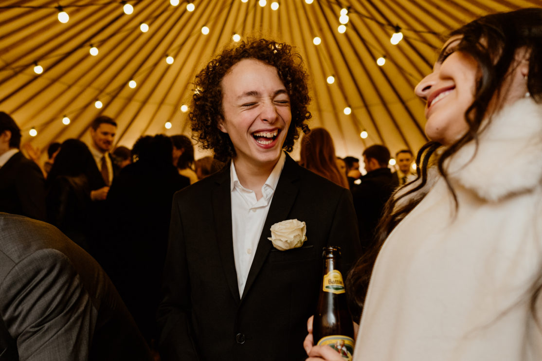 Weddings guests laughing at Old Luxters Barn, Buckinghamshire Wedding Photography