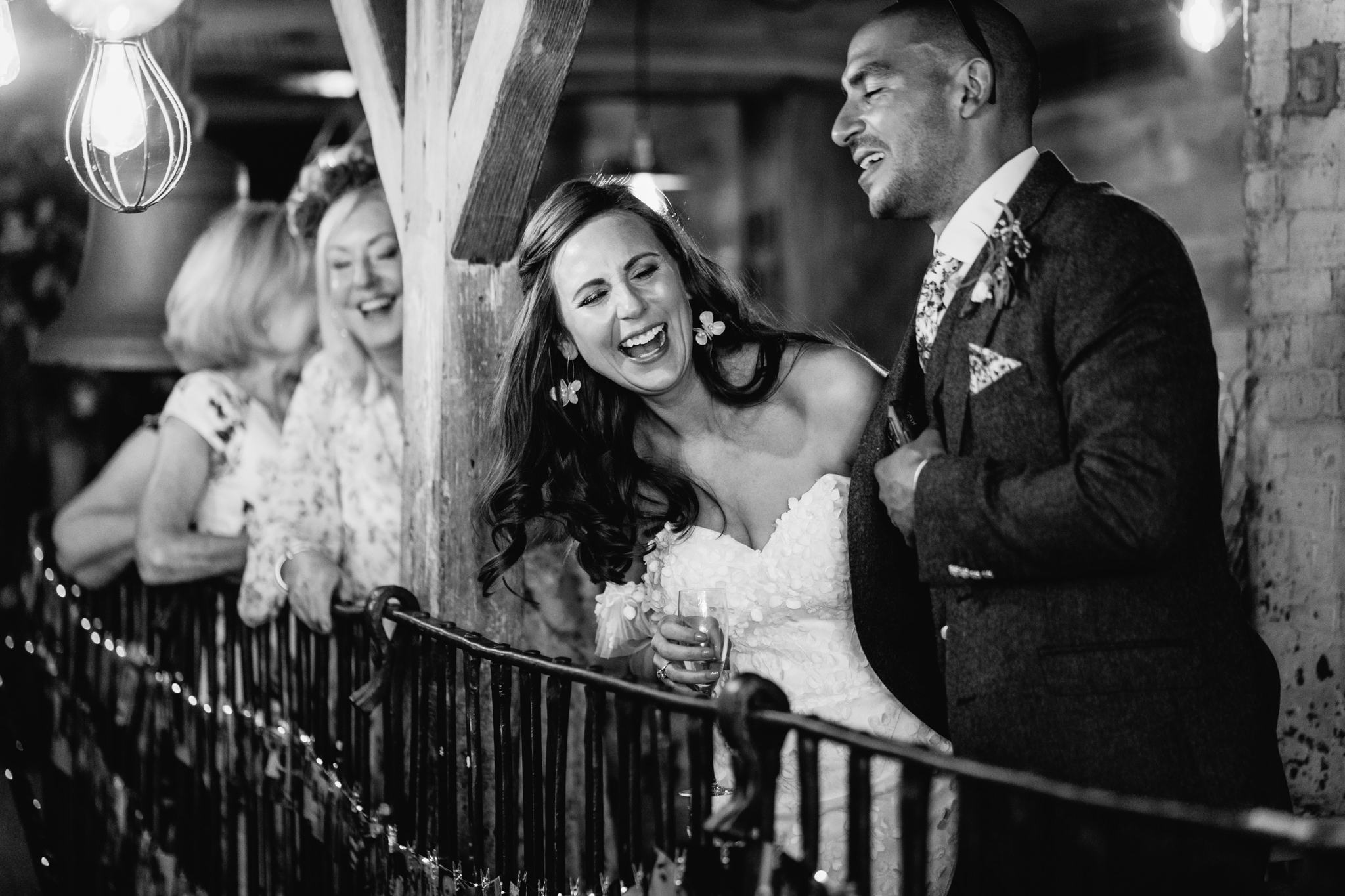 laughing bride during wedding speeches - documentary wedding photographer