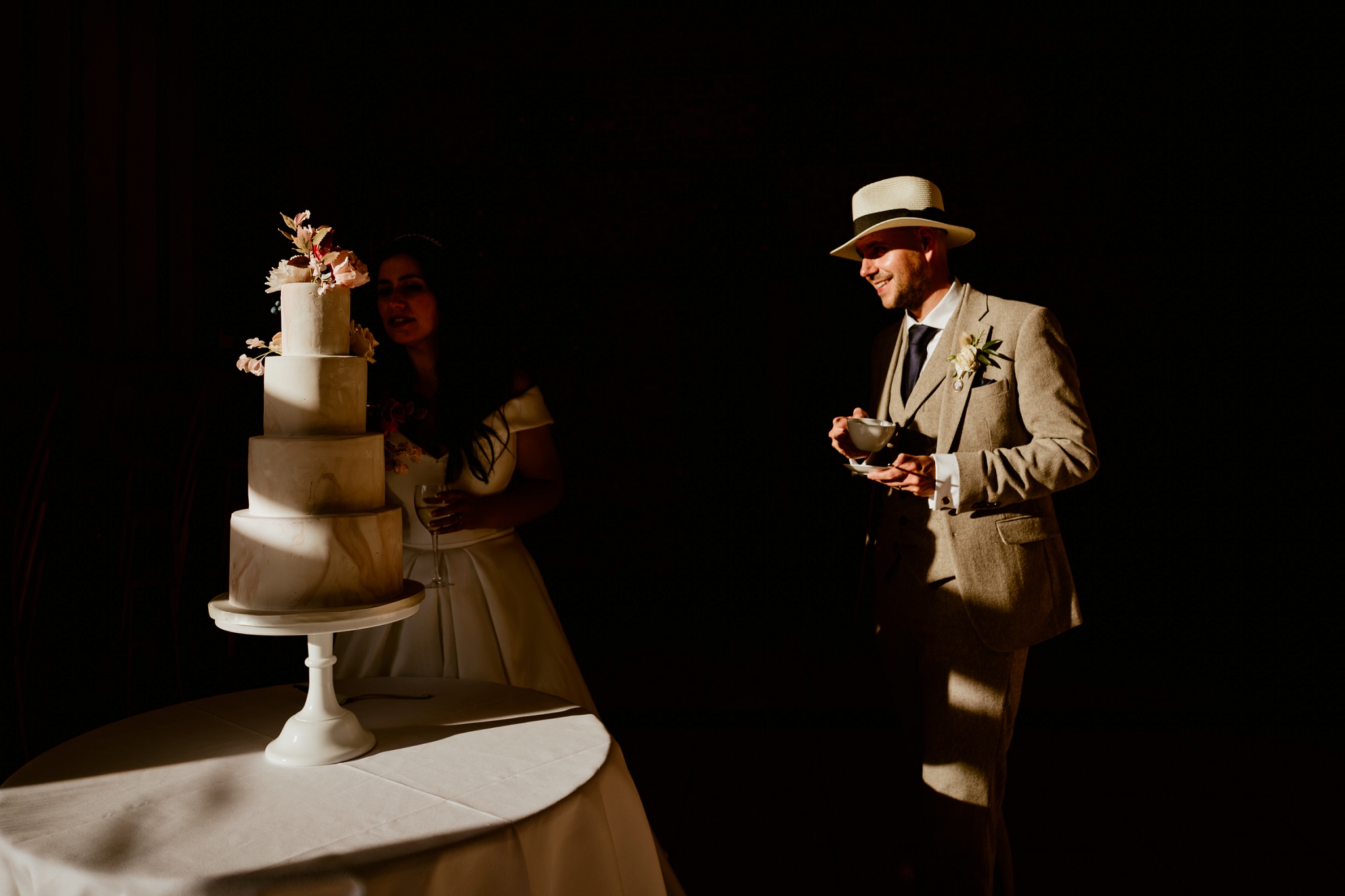 Wedding cake and couple - Buckinghamshire wedding. Artistic documentary wedding photography