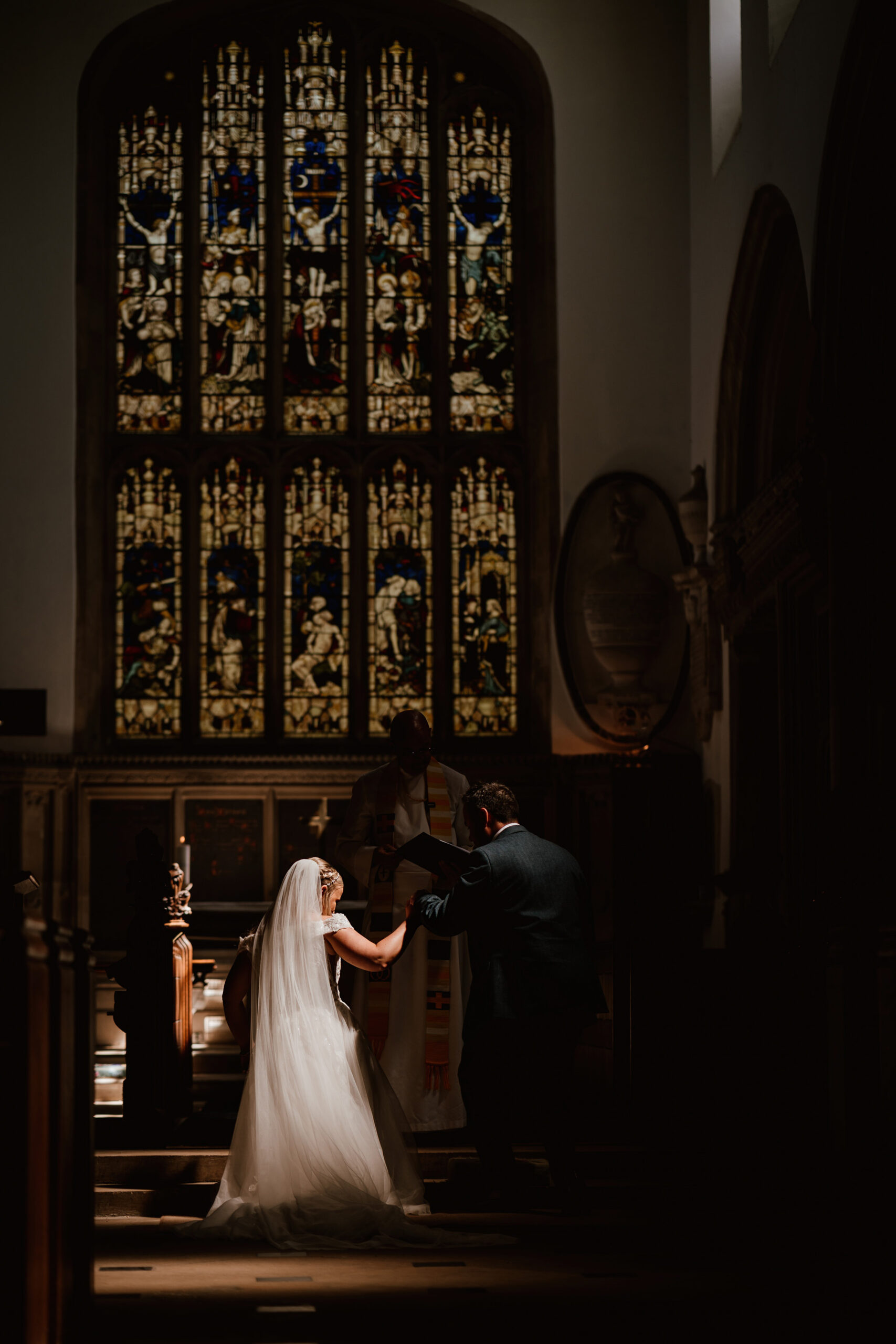 LIght on bride in church - fine art wedding photojournalism