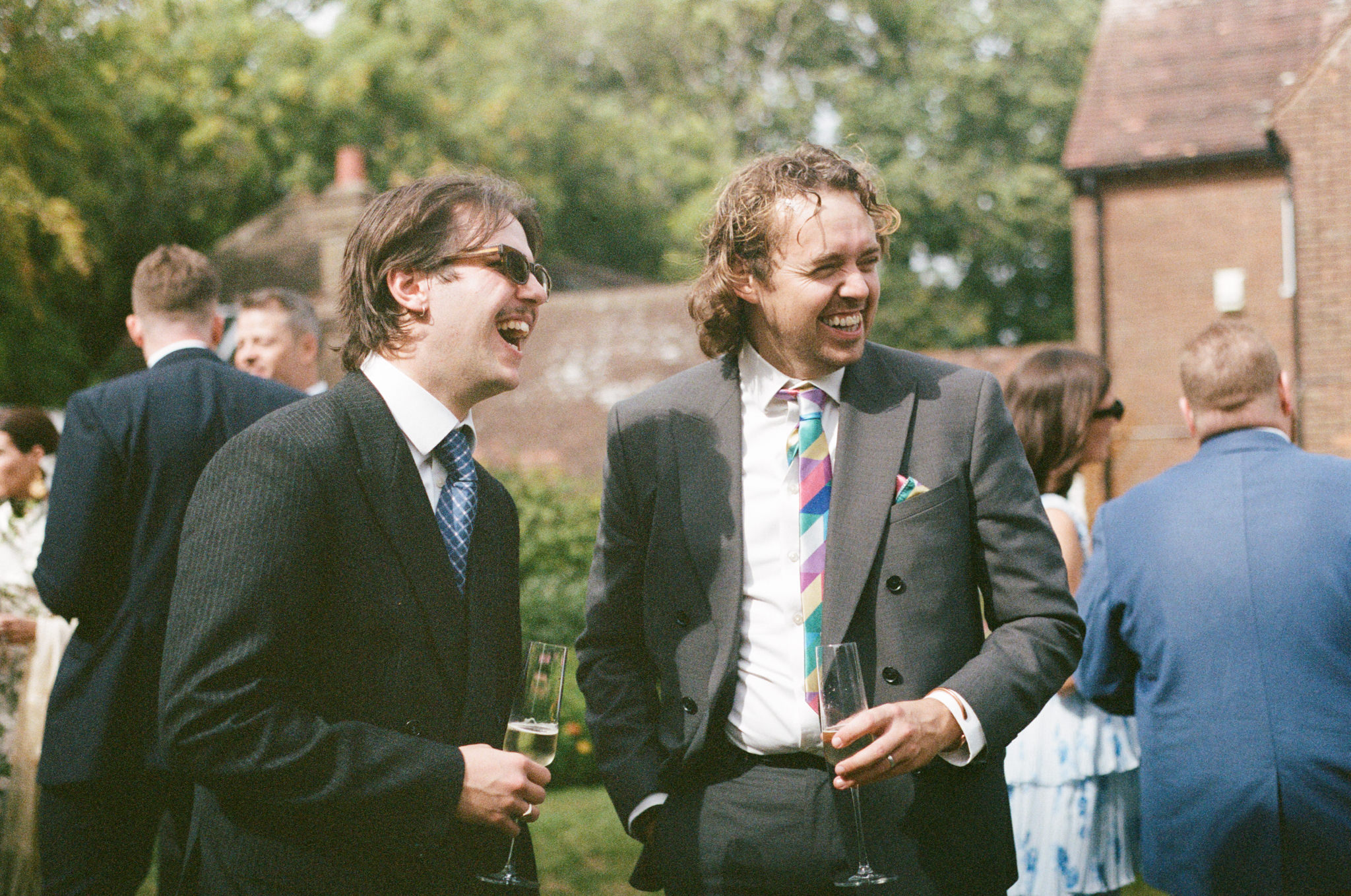 Guests pose happily at wedding - Bedfordshire Film Photographer