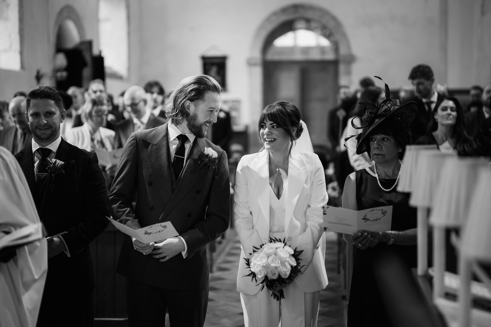 Bride and groom smiling at each other during the wedding ceremony - Just married - Bedfordshire Wedding Photographer