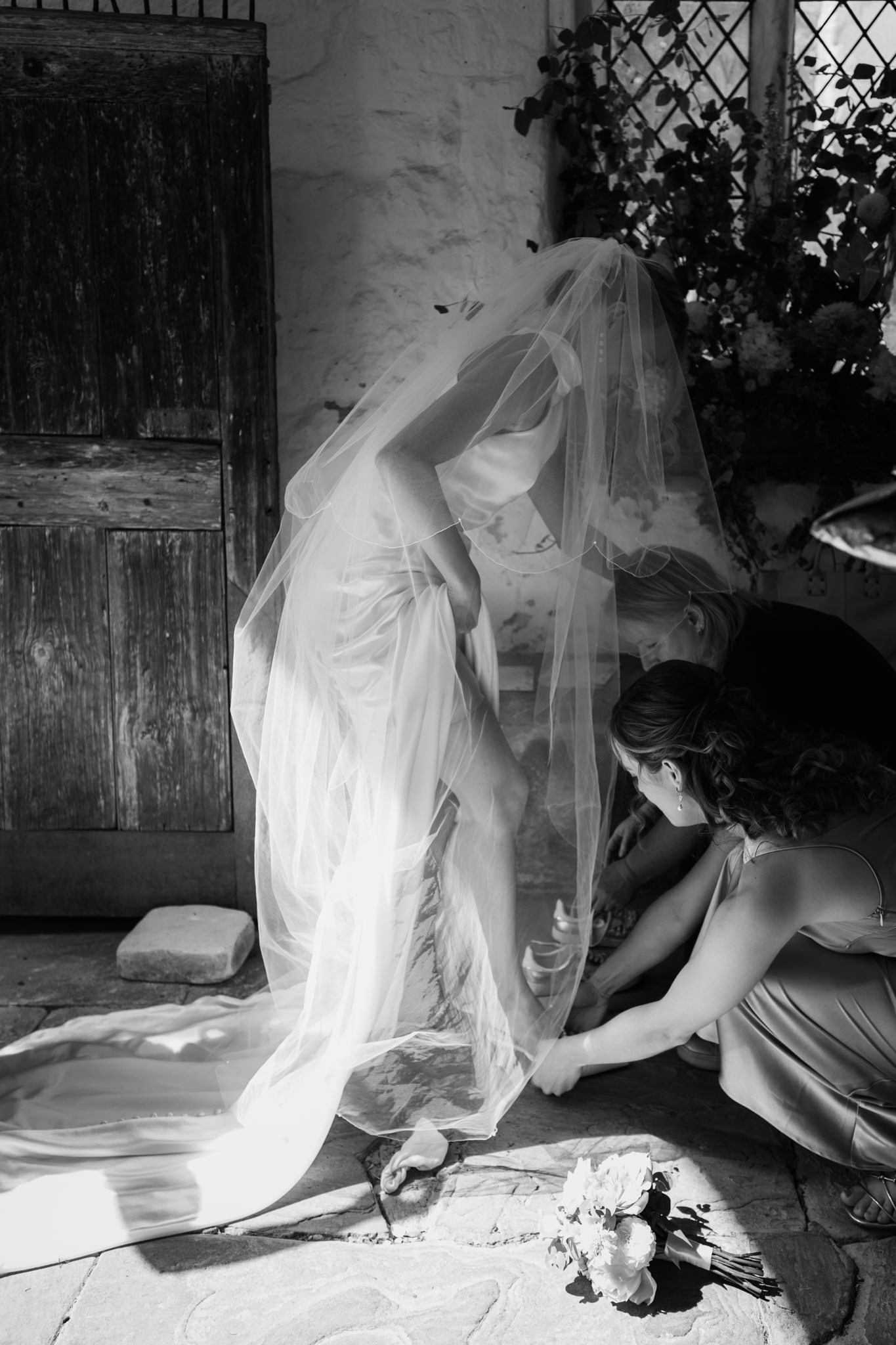 Bride changing her shoes before the wedding at Ashwell church - Hertfordshire wedding photographer